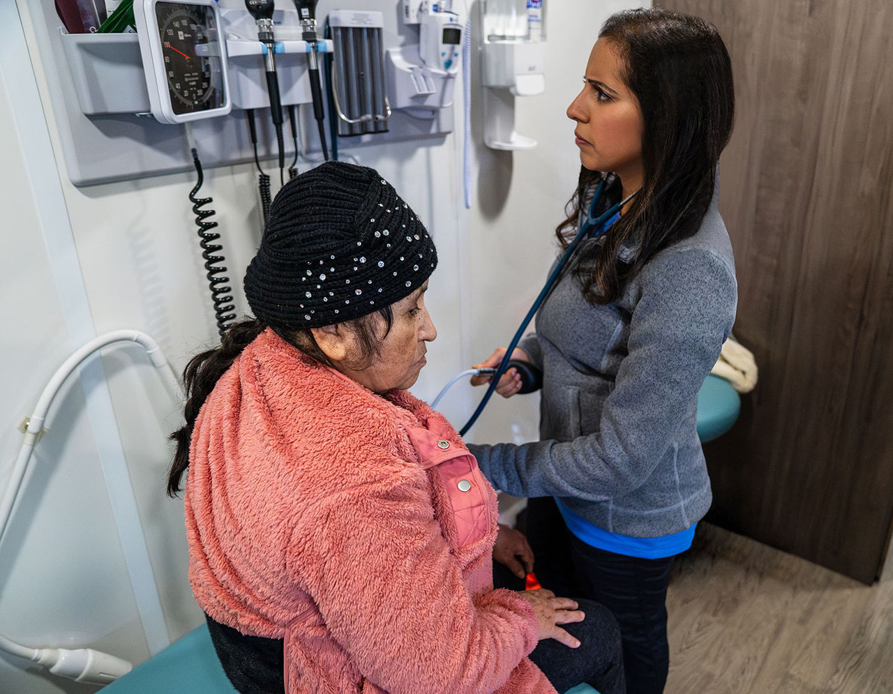 Dr. Priya Gupta takes blood pressure of a patient.