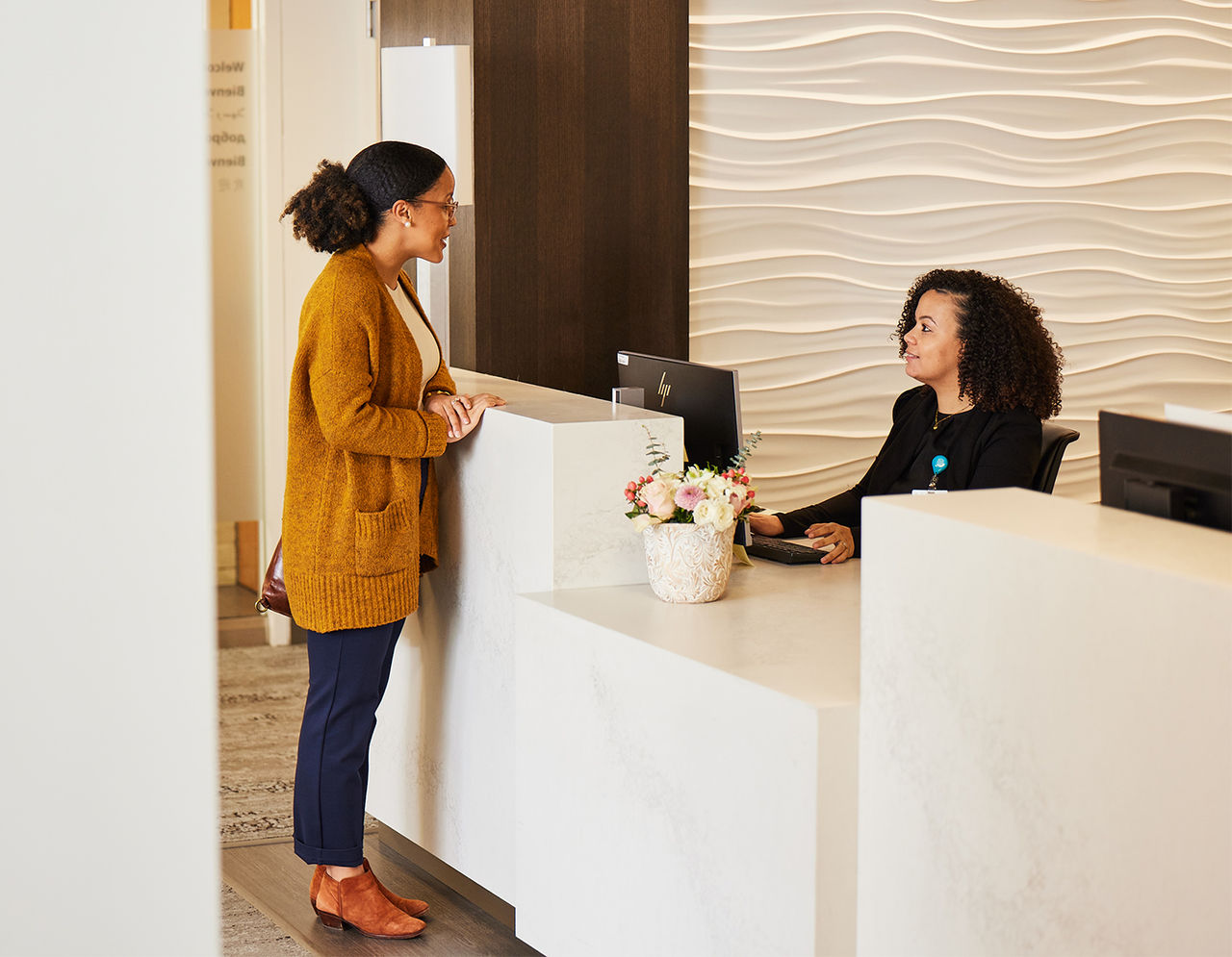 Tiffany Andrade German and Leila DaSilva at International Patient Center front desk